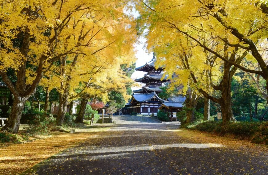 A serene autumn scene on Yellow Spring Road in Japan, leading to a traditional temple.