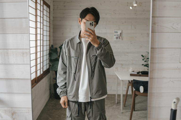 Japanese Mens Techwear Outfits: 5 Modern Functional Styles 2026! 24 Japanese man taking a mirror selfie wearing a functional lightweight jacket with modern cargo pants, clean minimal interior — japanese mens techwear outfits.