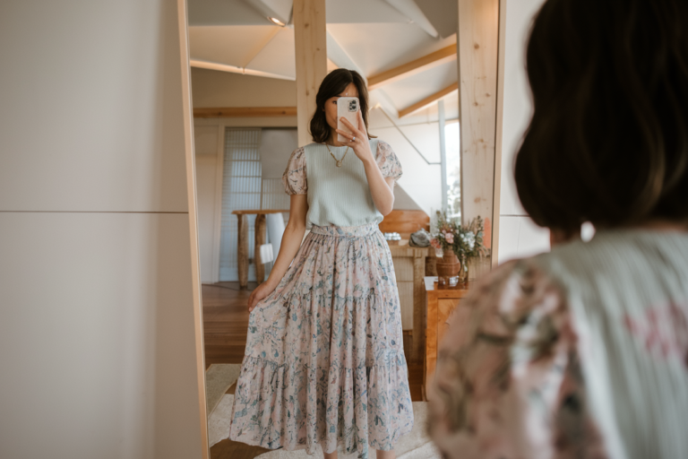 Japanese Women Spring Fashion: 5 Modern Seasonal Looks 2026! 22 Japanese woman taking a mirror selfie in an airy flowy spring skirt with pastel top, minimal warm interior — japanese women spring fashion.