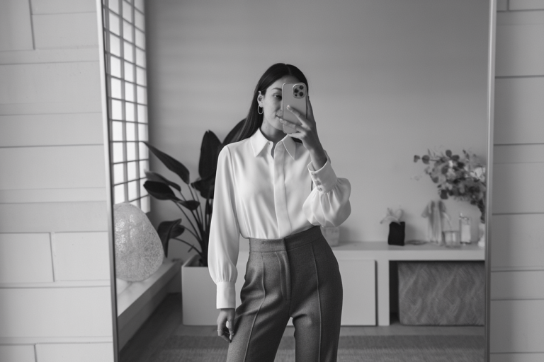 Women Luxury Business Basics: 5 Refined Office Looks with Premium Materials 2026! 7 Japanese woman taking a mirror selfie wearing an executive luxury business outfit with premium materials, calm professional setting — women luxury business basics.