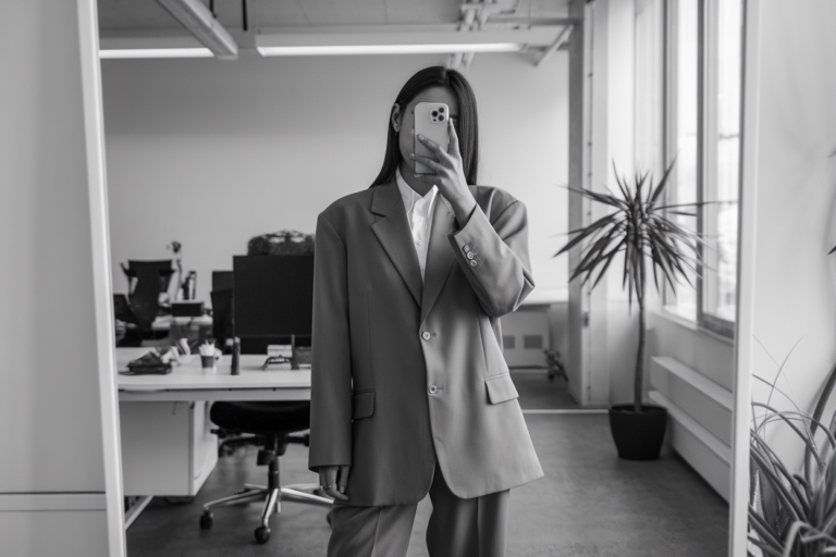 Women Oversized Blazer Business Look: 5 Modern Office Styles 2026! 5 Japanese woman taking a mirror selfie wearing an executive oversized blazer power outfit with balanced proportions, refined professional setting — women oversized blazer business look.